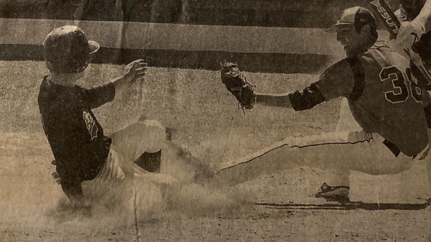 Sonny Hughey slides into home under the tag of the Doane pitcher